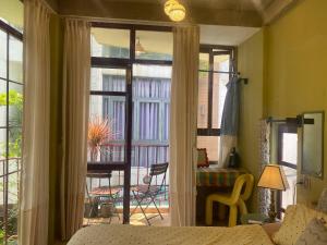 a bedroom with a sliding glass door to a patio at Tiny bright house Autum space in Danang