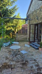 a table and two chairs on a stone patio at Pokój i Spokój Agroturystyka in Zacisze