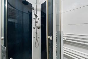 a shower with a glass door with a handle at Appartement centre de Crozon in Crozon +12 photos