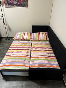 a bed with two colorful pillows on top of it at Apartment Martinec in Nové Město nad Metují +23 photos