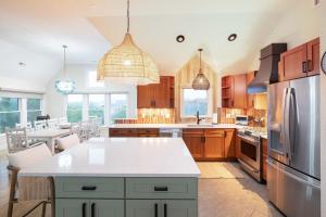 a kitchen with wooden cabinets and a white counter top at Duck Resort with Ocean Views Pool HotTub Elevator in Kitty Hawk Beach