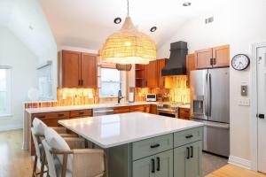 a kitchen with a large island with a white counter top at Duck Resort with Ocean Views Pool HotTub Elevator in Kitty Hawk Beach +70 photos
