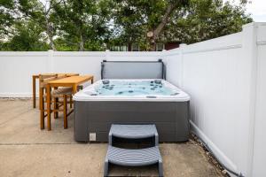 a hot tub sitting next to a white fence at Duck Resort with Ocean Views Pool HotTub Elevator in Kitty Hawk Beach