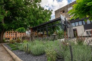 a building with a garden in front of it at Vila Hera Spa in Vrbas