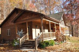 a log cabin with a porch and stairs to a house at Millstone Lodge Cabin in Bryson City +33 photos