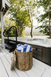 a basket of towels sitting next to a bath tub at Luxurious Lakeside Chalet with Swim Spa in South Brook