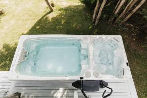 a hot tub sitting on the ground in the yard at Luxurious Lakeside Chalet with Swim Spa in South Brook