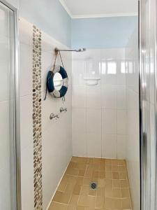 a shower with a glass door in a bathroom at Blue on Cockle in Picnic Bay
