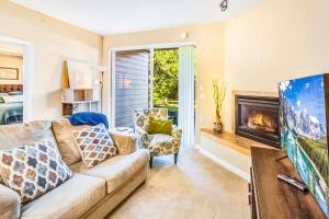 a living room with a couch and a fireplace at 2BR Oyhut Bay Condo Fireplace Private Deck in Ocean Shores