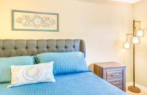 a bedroom with a blue bed with blue pillows at 2BR Oyhut Bay Condo Fireplace Private Deck in Ocean Shores