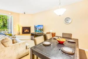 a living room with a table and a couch at 2BR Oyhut Bay Condo Fireplace Private Deck in Ocean Shores +41 photos
