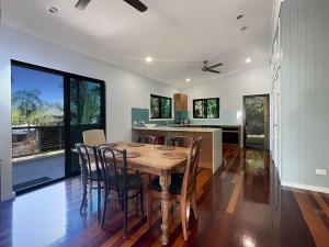 a kitchen and dining room with a table and chairs at Debs Shed in Arcadia +22 photos