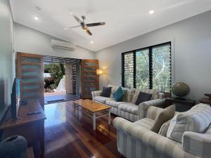 a living room with couches and a ceiling fan at Debs Shed in Arcadia