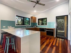 a kitchen with a white counter top and some windows at Debs Shed in Arcadia