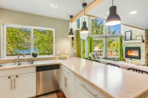 a kitchen with a sink and a counter top at A-Frame Cabin Dock Access & Views BBQ in Hoodsport