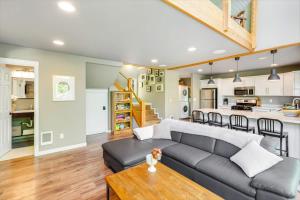 a living room and kitchen with a couch and a table at A-Frame Cabin Dock Access & Views BBQ in Hoodsport +48 photos