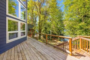 a large wooden deck on a house at A-Frame Cabin Dock Access & Views BBQ in Hoodsport