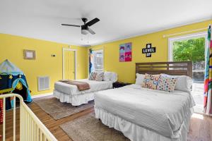 a bedroom with two beds and a ceiling fan at 2 Bed 1 Bath Private Suite Funky Bunch TYSUT in Louisville