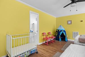 a room with a crib and a play tent at 2 Bed 1 Bath Private Suite Funky Bunch TYSUT in Louisville
