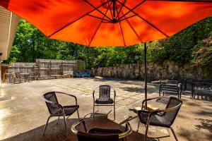 a patio with two chairs and an umbrella at 2 Bed 1 Bath Private Suite Funky Bunch TYSUT in Louisville