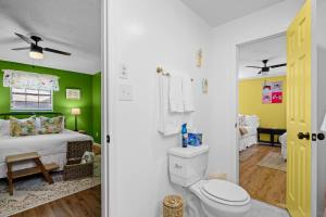 a bedroom with green walls and a bed with a toilet at 2 Bed 1 Bath Private Suite Funky Bunch TYSUT in Louisville +19 photos