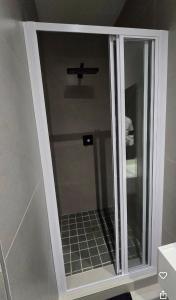 a glass shower door in a bathroom at Lehumo Guesthouse in Mogales +6 photos