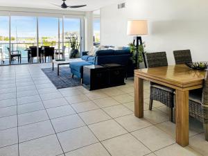 a living room with a couch and a table at Blue on Blue Apartment 933 in Nelly Bay