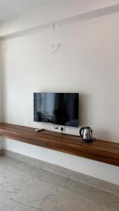 a flat screen tv sitting on a wall at Vortex Suites in Guwahati