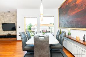 a dining room with a table and chairs at Residence Almarea by Locap Group in Izola
