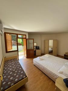 a bedroom with a bed and a desk and a window at Orpheus Hotel in Varna City