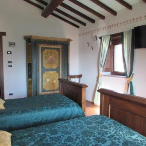 Rúm í herbergi á B&B Dagnano Basso