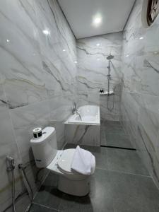 a white bathroom with a toilet and a sink at Casa De Brillo Tegallalang in Tegalalang +20 photos