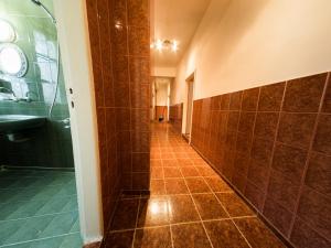 a bathroom with a shower and a tiled hallway at Serdika Rooms in Sofia