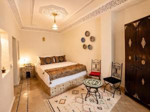 a bedroom with a bed and a table at Riad Fes Layan in Fez +16 photos
