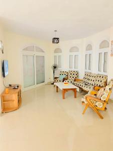 a large living room with couches and a table at Luxury Duplex Villa for Rent in Dawwār Muḩammad Abū Shanab