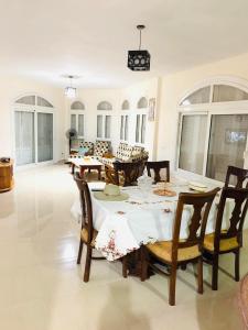 a dining room with a table and chairs at Luxury Duplex Villa for Rent in Dawwār Muḩammad Abū Shanab