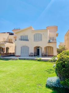 a large house with a lawn in front of it at Luxury Duplex Villa for Rent in Dawwār Muḩammad Abū Shanab +15 photos