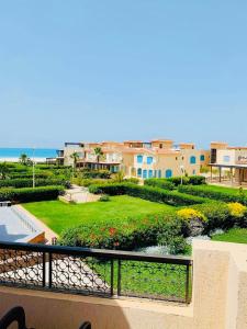 a view of a garden from the balcony of a resort at Luxury Duplex Villa for Rent in Dawwār Muḩammad Abū Shanab