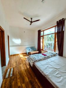 a bedroom with a large bed and a window at North Sky Stays Bir in Bīr