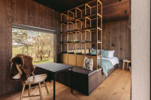 a bedroom with a bed and a desk and a table at Owl in St. Andrews