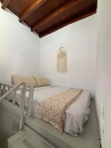 a bedroom with a bed and a chandelier at Bougainvillea in Asklipiḯon