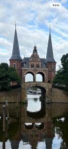 a building with a bridge over a body of water at Logement Hoogend in Sneek