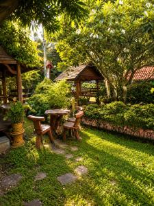 a garden with a table and benches and a gazebo at Röstiland by NOXAMA SAMUI in Lamai +8 photos