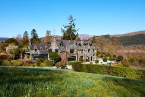 an estate with a large house on a hill at Penmaenuchaf Hotel in Dolgellau