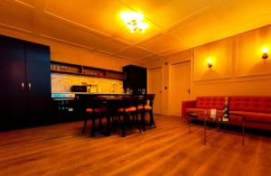 a living room with a red couch and a table at Canal View Lodge & Spa - Entire 3 Bed Lodge in Longford