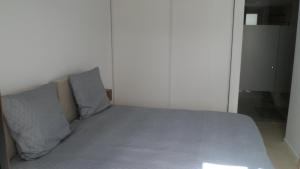 a bed with two pillows on it in a bedroom at Villa Ceesito in Los Alcázares