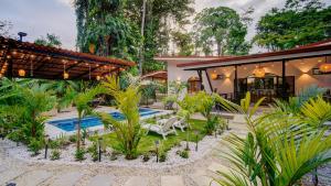 a resort with a swimming pool and a house at Casa AMALFI Pool House Playa Neg in Puerto Viejo