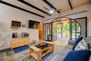 a living room with a couch and a table at Casa AMALFI Pool House Playa Neg in Puerto Viejo