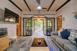 a living room with a couch and a table at Casa AMALFI Pool House Playa Neg in Puerto Viejo