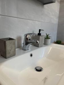 a bathroom sink with a faucet on top of it at Giouli's Maison in Eretria +32 photos